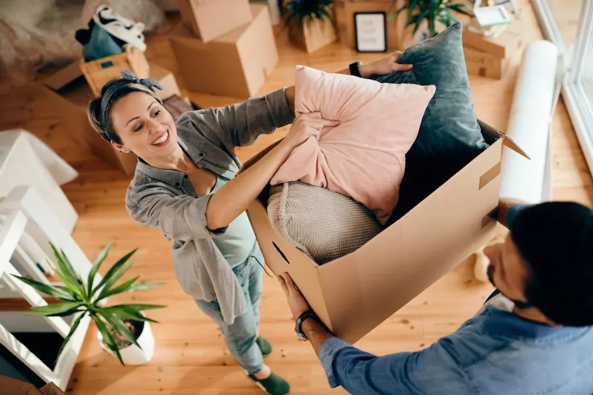 Professional mover in uniform carrying moving boxes in Dallas, TX