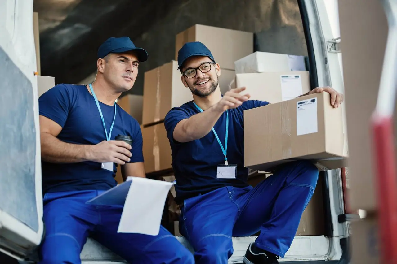 Moving specialist reviewing inventory with clipboard