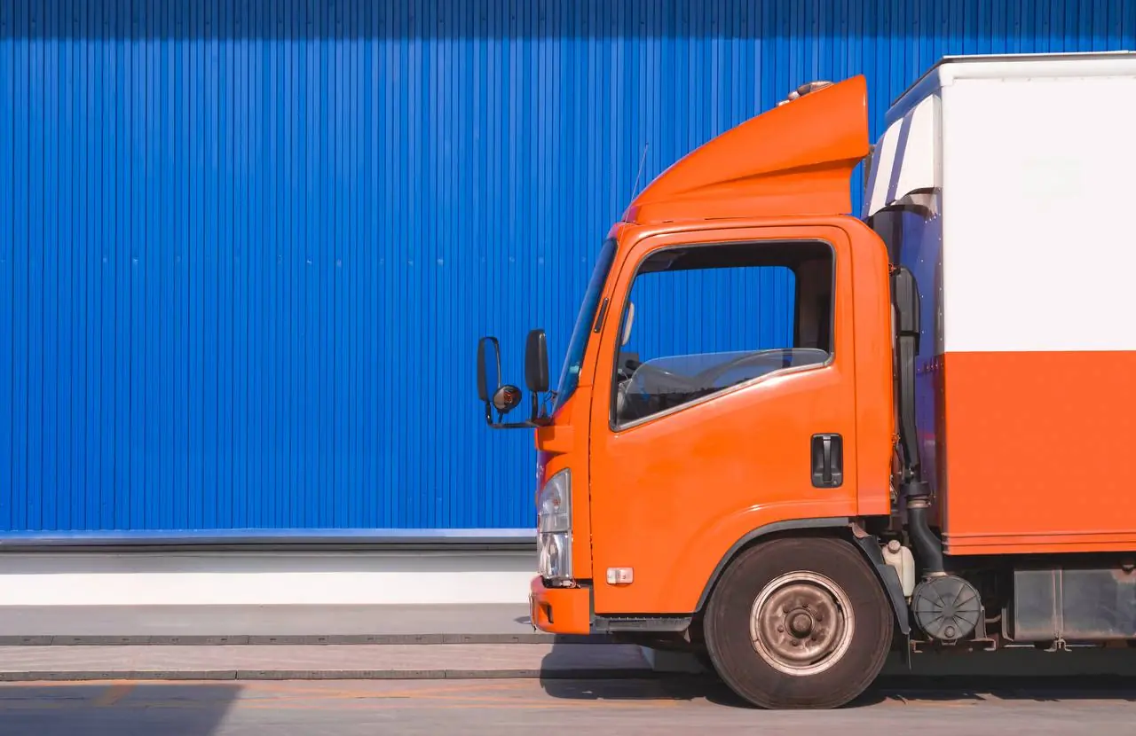Professional movers loading sofa onto interstate moving truck