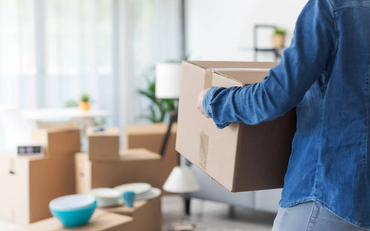 Movers unloading boxes at new home on delivery day