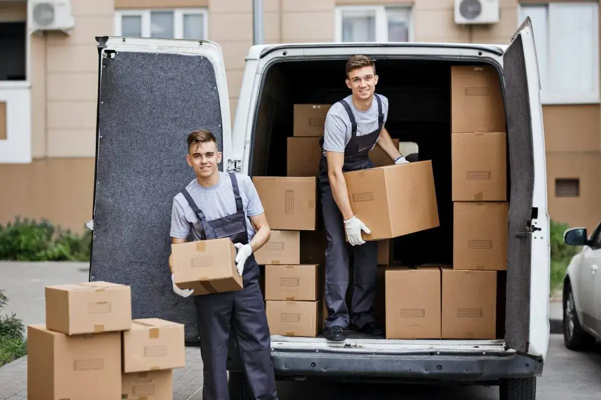 Two professional movers loading boxes into moving van in Chicago, IL